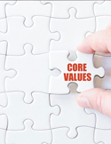 A hand placing a white puzzle piece with the words "CORE VALUES" into a nearly finished jigsaw puzzle.