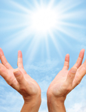 Two hands reach upward toward a bright, radiating sun in a clear blue sky.