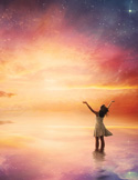 A woman stands in shallow water with arms raised toward a vast, glowing sunset sky filled with stars.