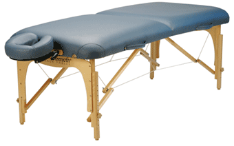 Portable massage table with a light blue padded surface, wooden frame, and an adjustable face cradle.